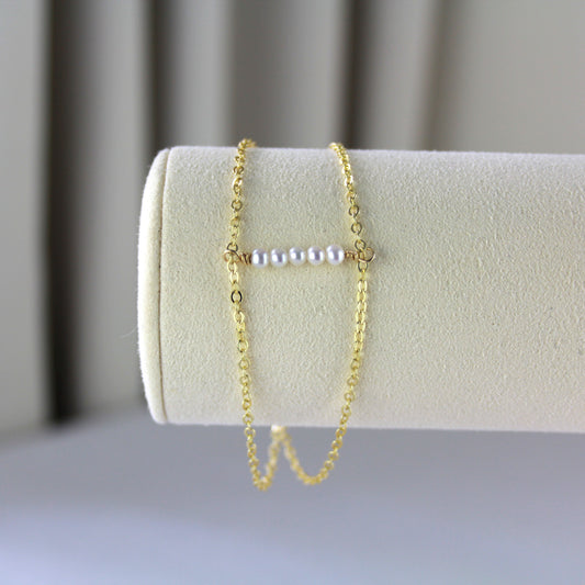Dubbele gouden schakelketting met parels